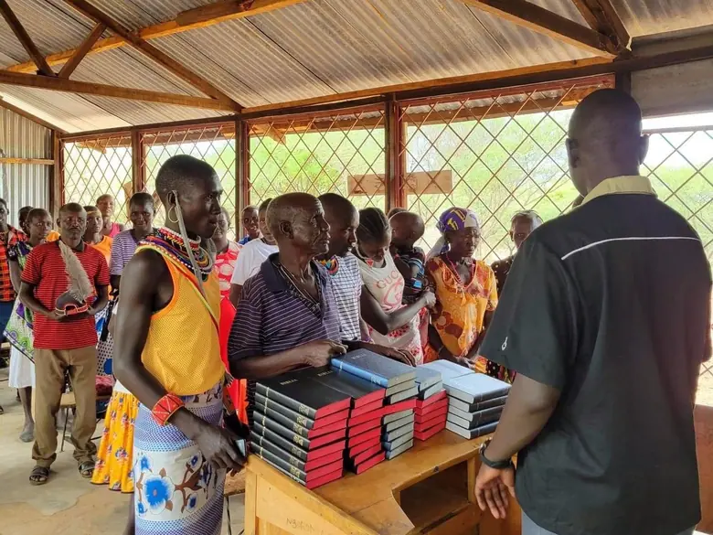 Runners hand-delivering Bibles to a waiting community