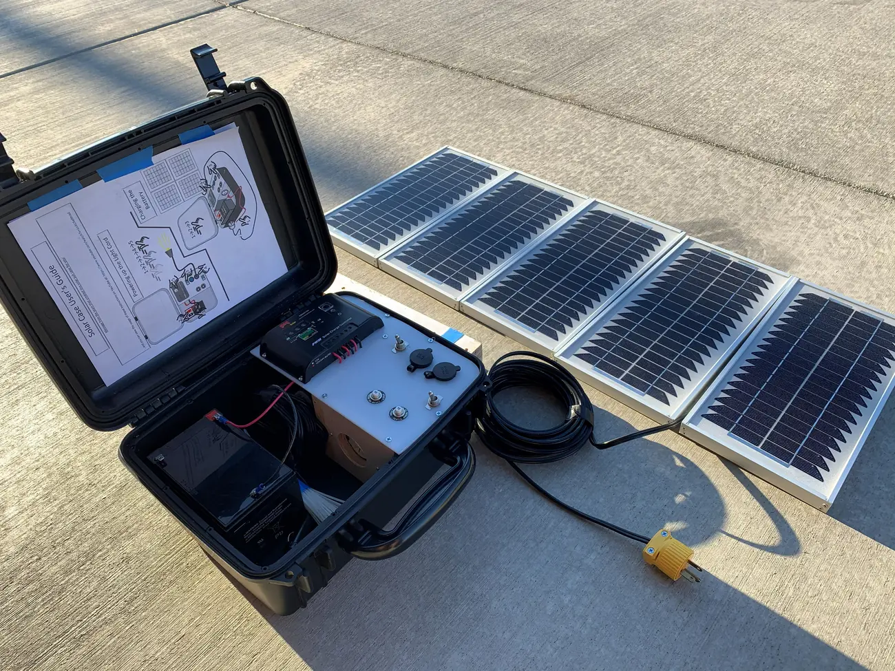 The VillageServer field kit — solar panels and equipment packed in a travel case