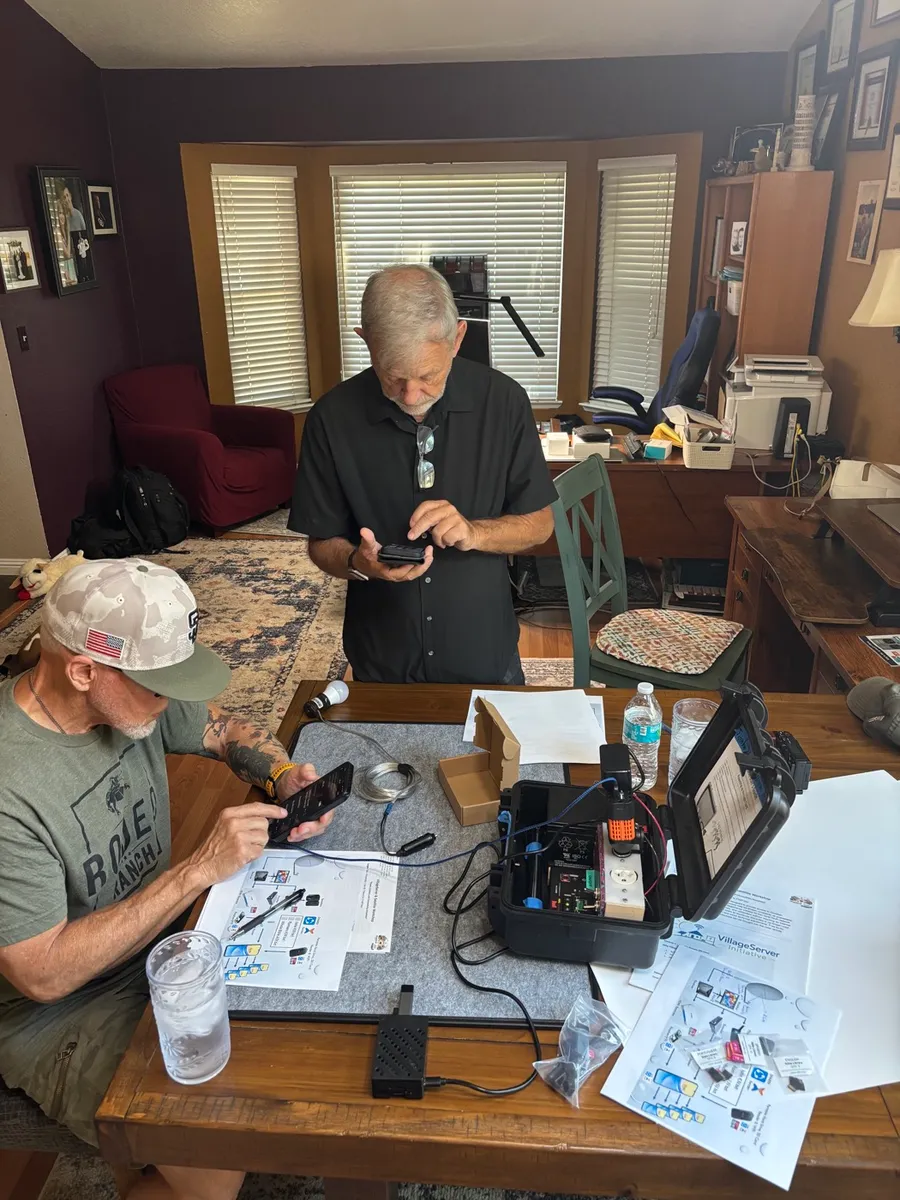 Team testing phones and the VillageServer case indoors
